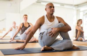 man practicing Matsyendrasana known as Lord of Fishes Pose in yoga